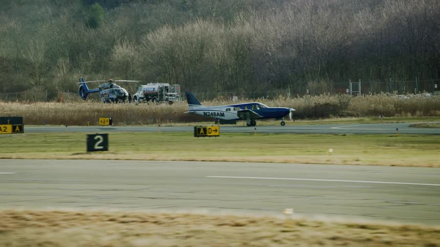 A small airplane starts to take off from the airstrip