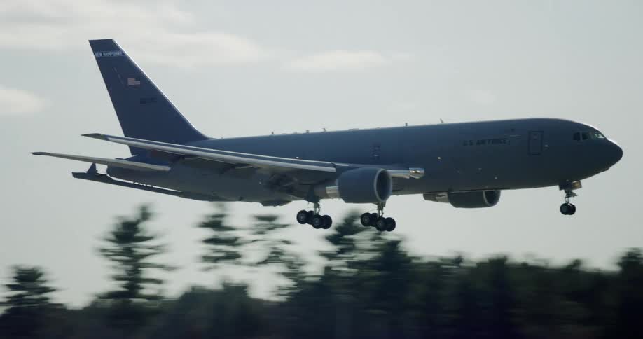A large commercial airplane descends and lands on a runway