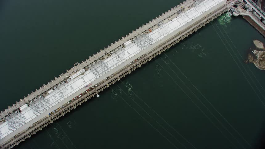 Aerial view of a bridge in the ocean is displayed