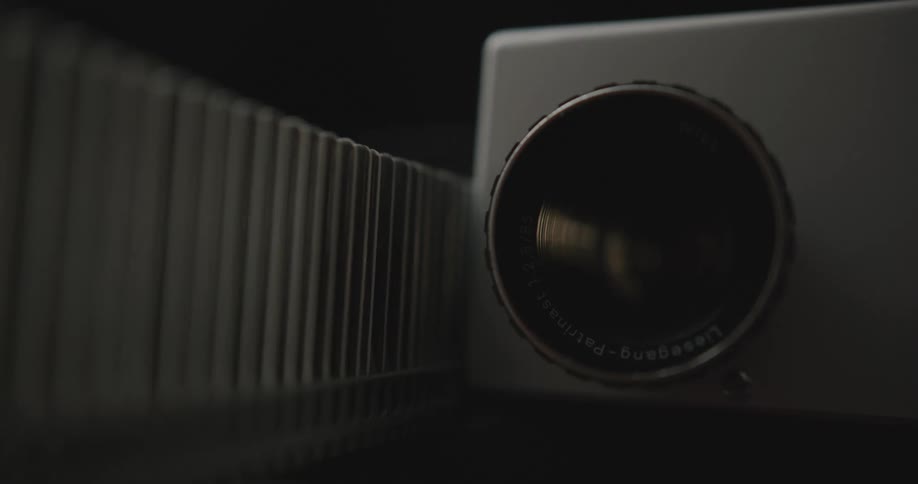 A slide projector light turns on and off as the slides are projected