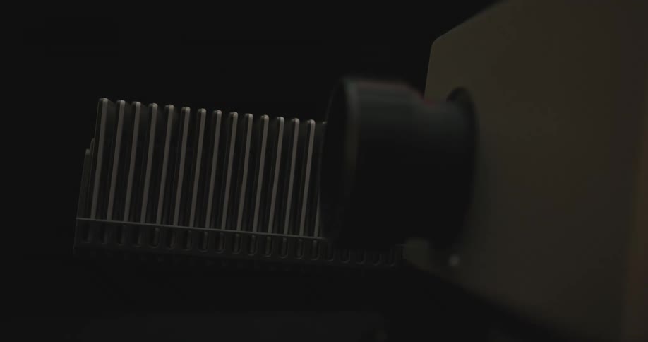 A slide tray moves along as the slide machine flashes the slides one by one