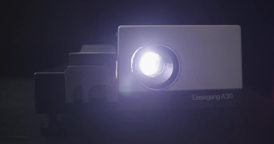 A projector device with a blinking light indicating its operation