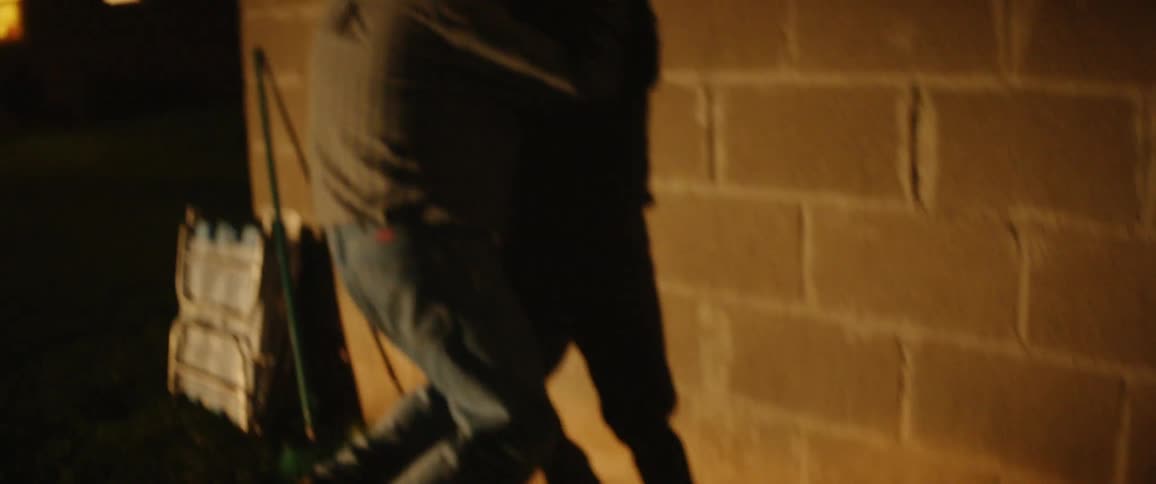 Person slams their hands leaning against a wall facing it