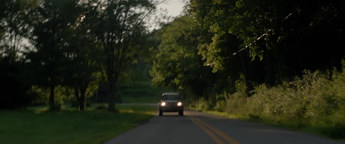 A vehicle travels on a country road