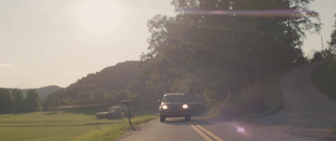 Truck drives down a country road