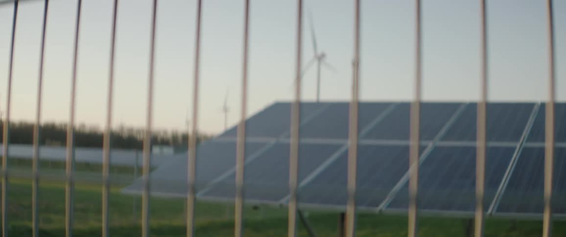 A wind farm behind a fence