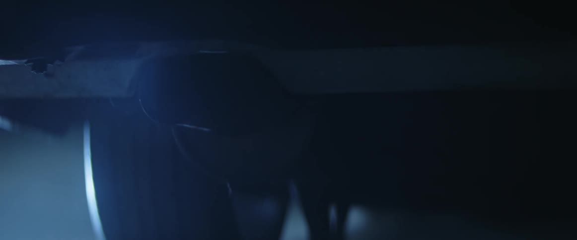 The tail pipe of a vehicle with exhaust fumes coming out of it
