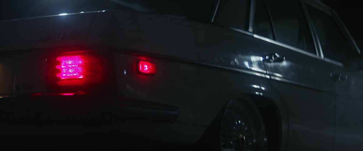 Tail lights illuminating on a car at night