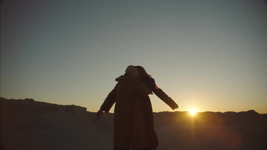 A man and woman hug