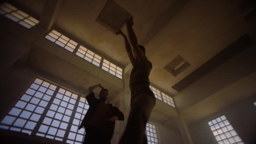 Two men are dancing in the dark