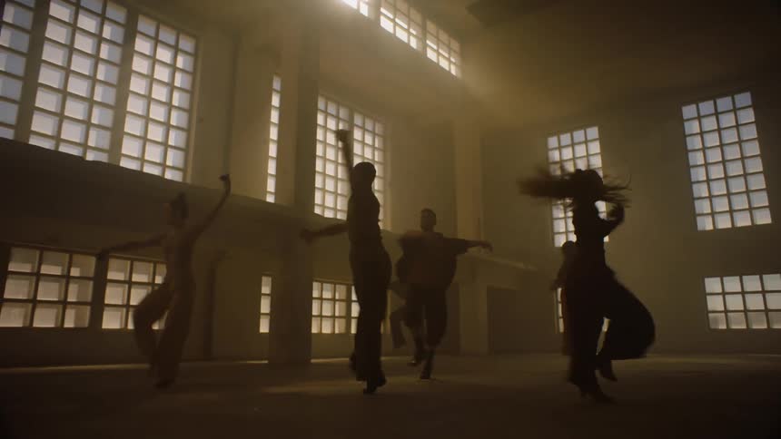 A group of people are dancing together indoors