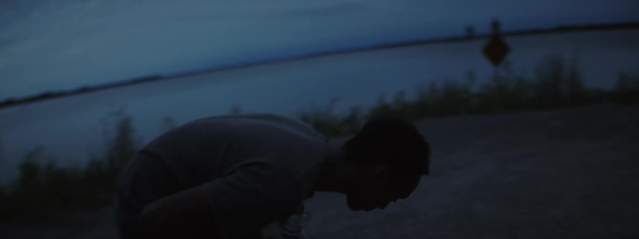 Two mens silhouettes while one man drinks and the other laughs and takes the bottle from the first man