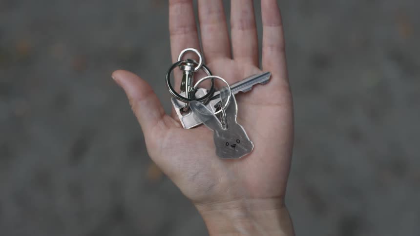 Hand with keys resting on palm grasps as if just caught