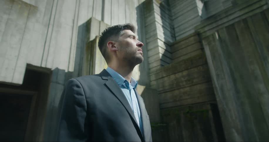 A man is standing outdoors next to a building
