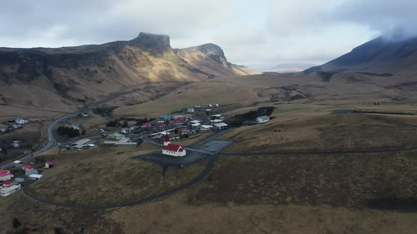 An aerial view of a village in a mountain