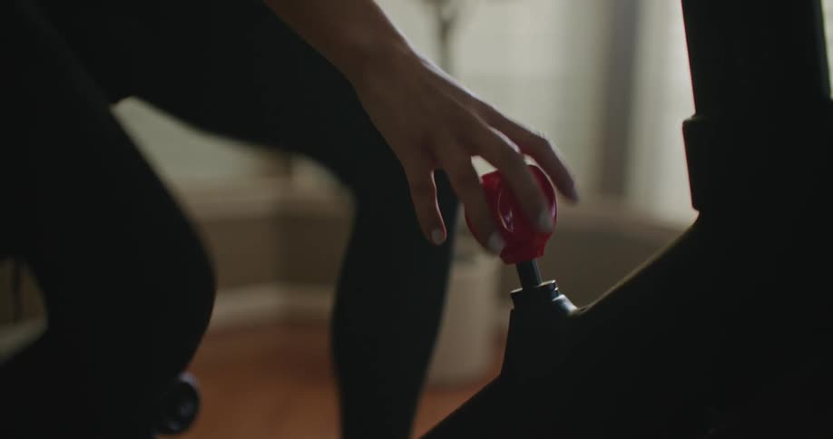 A woman working out on a stationary bike at home