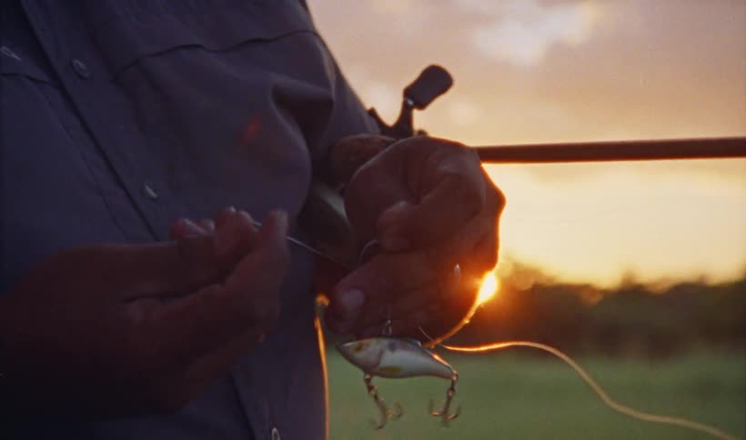 A man is putting bait on his hook