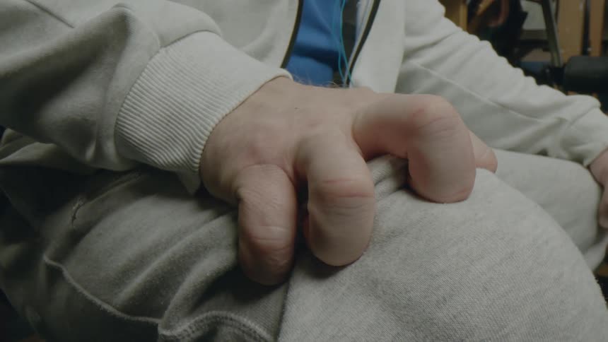 A man having a cramp grips his leg