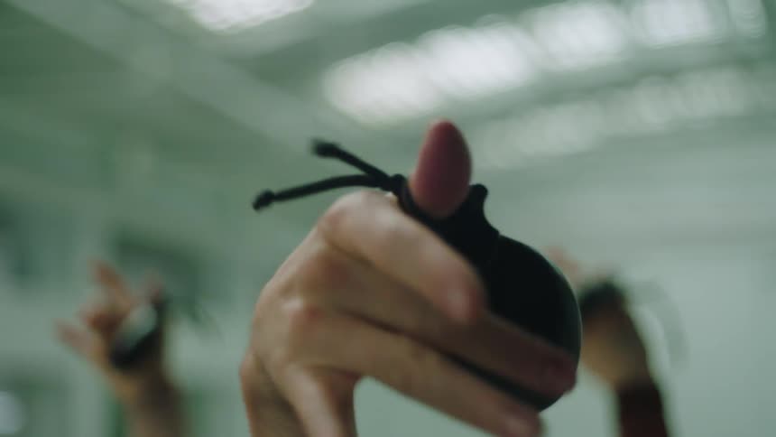 Three hands in the air play castanets vigorously
