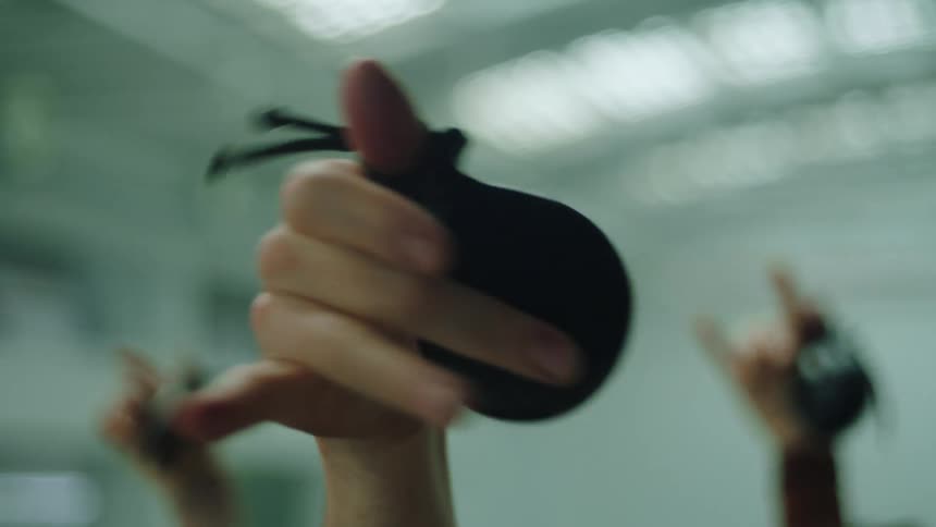 Dancers play castanets in large room lit by skylights