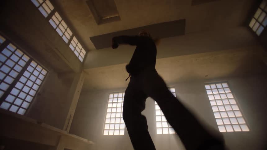 A man is dancing in the dark room
