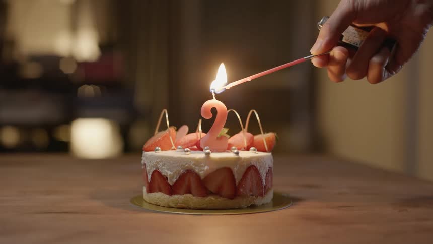 A view of a cake with candles on it being lit