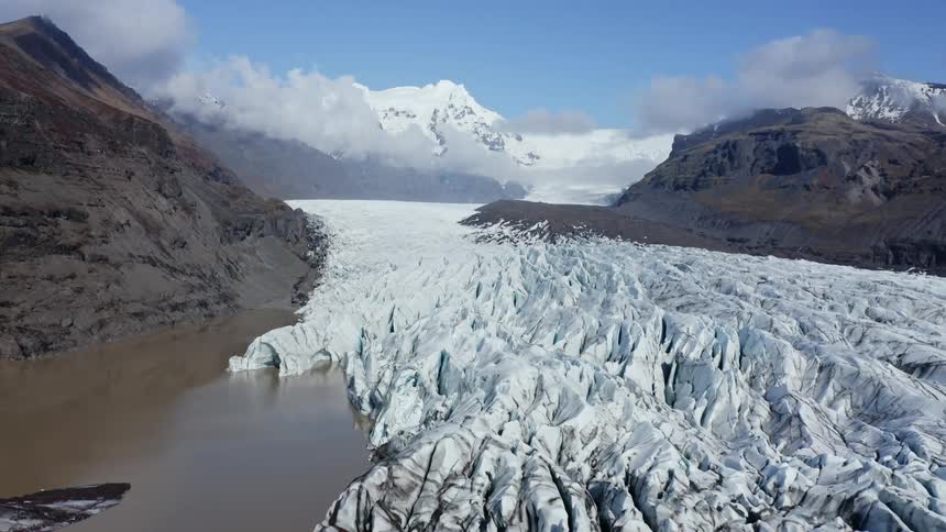 Snow covered mountains are displayed at midday