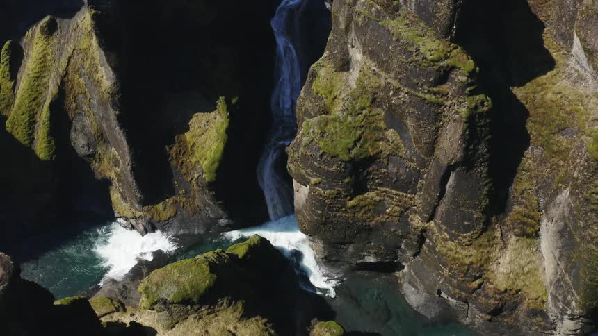 The waterfall runs into the stream