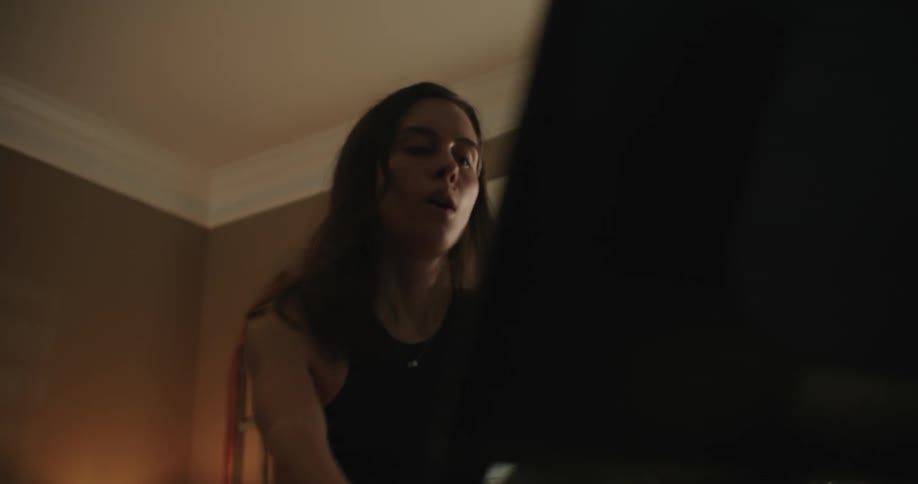 Woman pedals on exercise machine in room at home