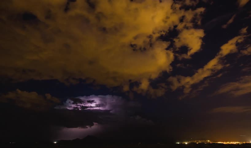 Time lapse of a skyline with lighting flashing