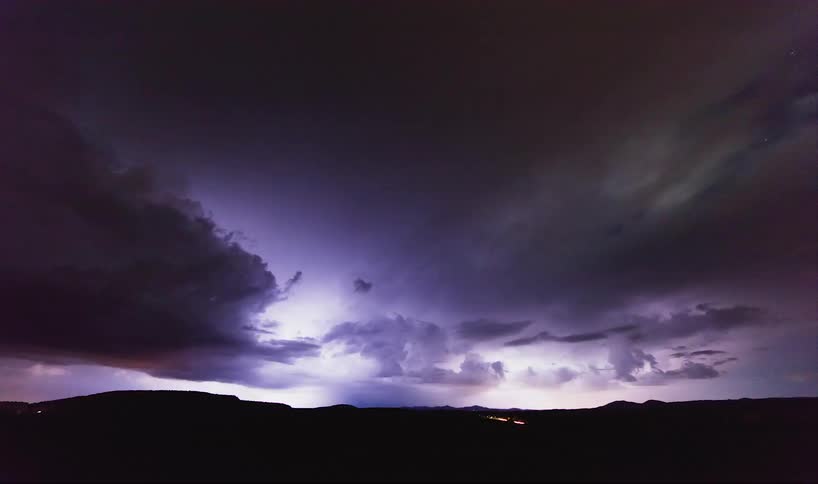 Lightning flashing and clouds flowing in the night sky