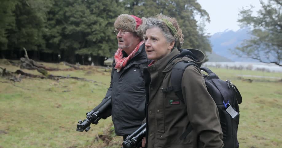 Elderly photographers walking in the wilderness with their equipment