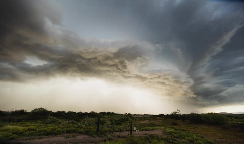 Time lapse of storm clouds moving over a field