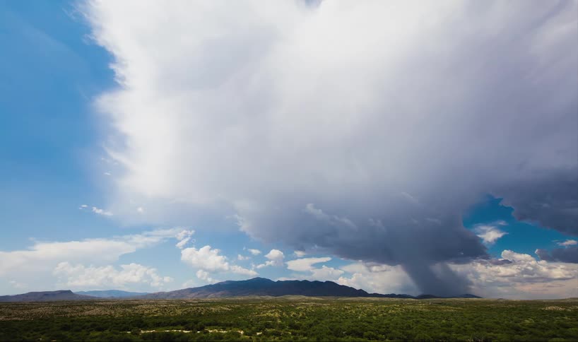 Time lapse of clouds moving over a skyline