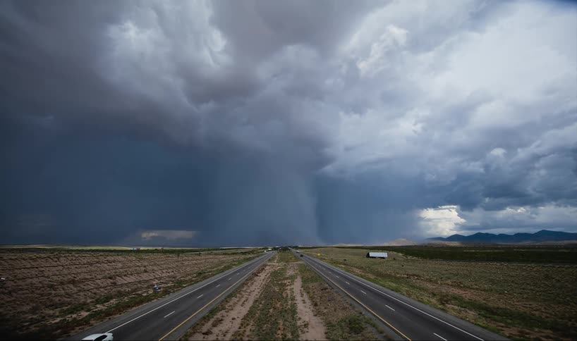 Time-lapse of a tornado forming and moving across a highway