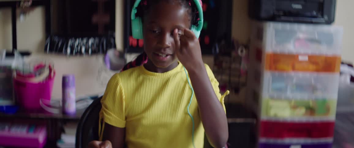 Young girl learning sign language from laptop at home