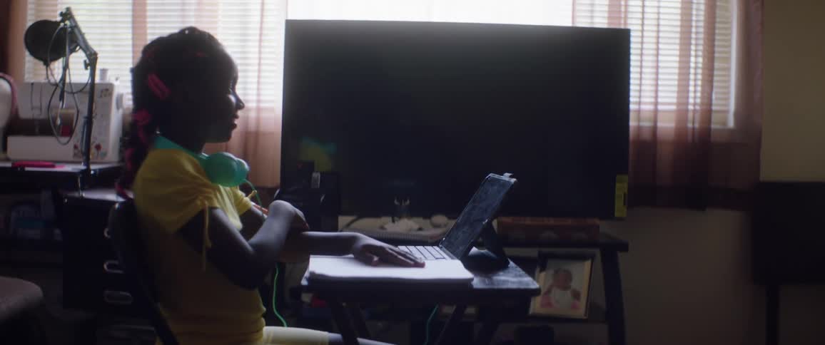 Young girl sitting in front of a laptop is being homescooled