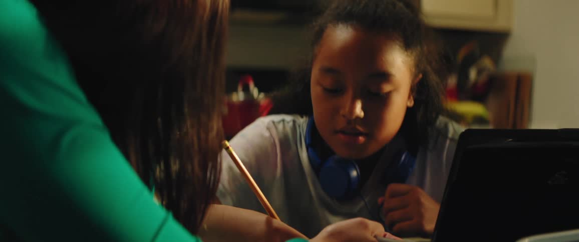 A woman is helping a child with homework