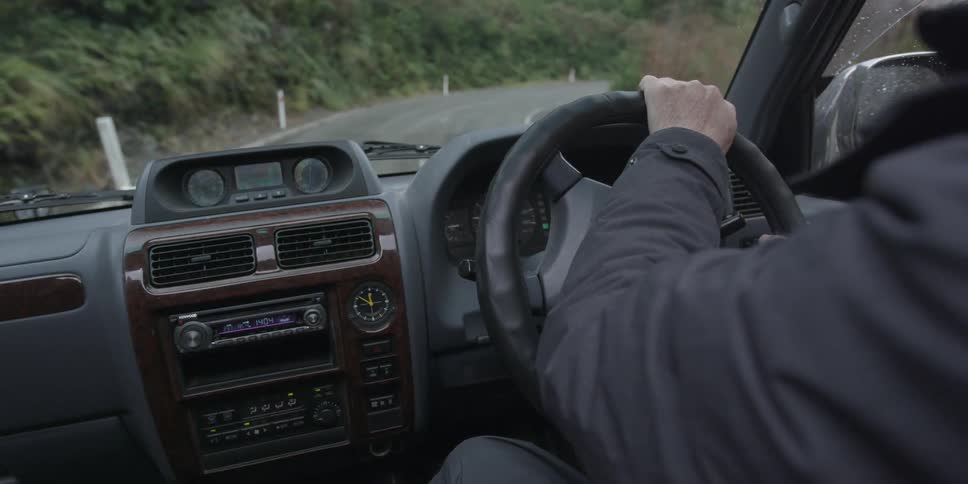 A person is driving along a curved road