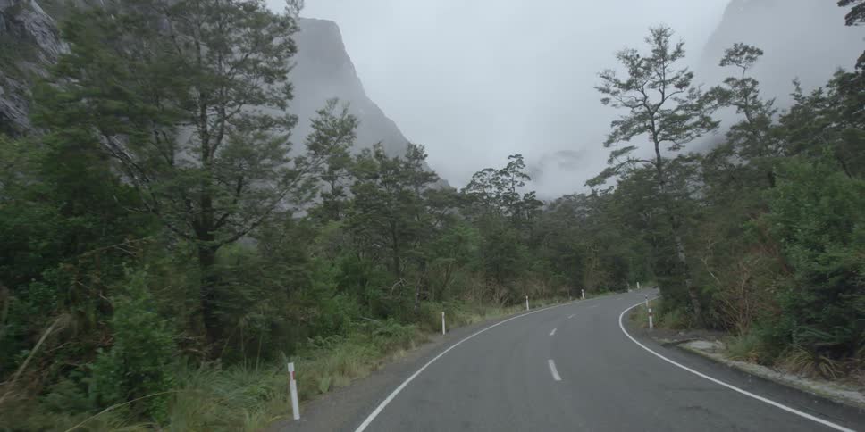 A winding road is on the side of a mountain