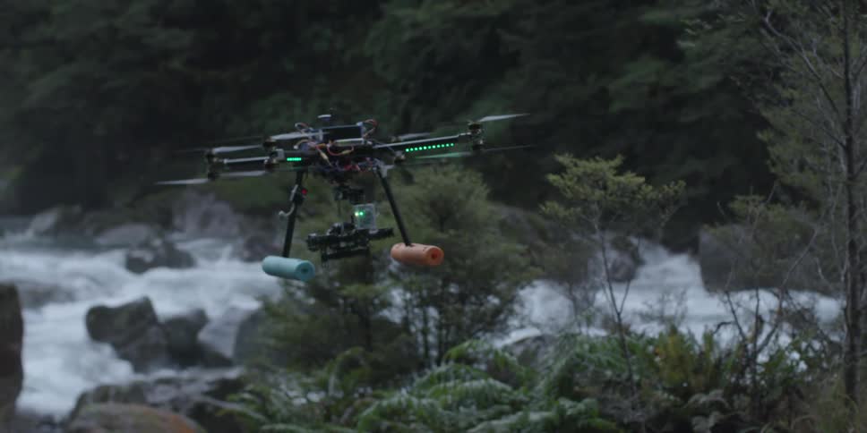 A person is controlling a drone that flies forward slowly