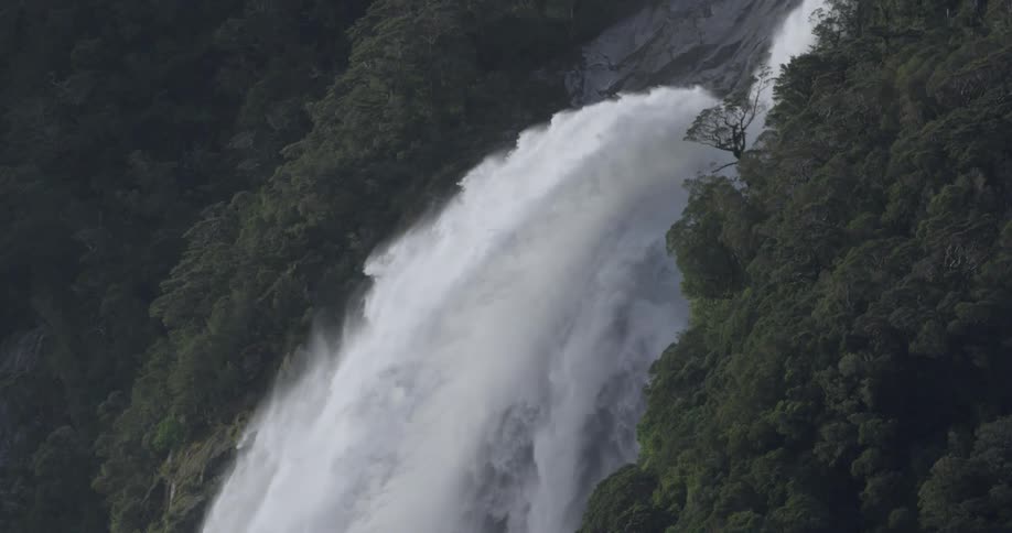A waterfall is rushing water out very fast