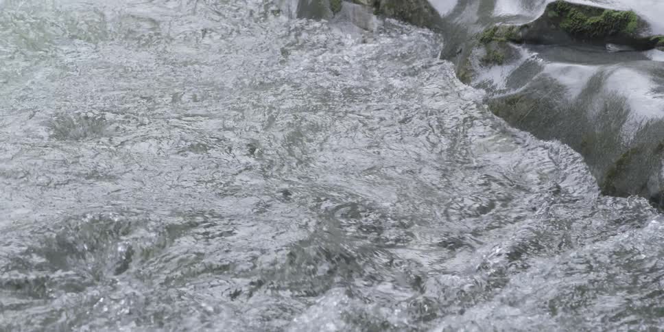 Water rushes past some rocks