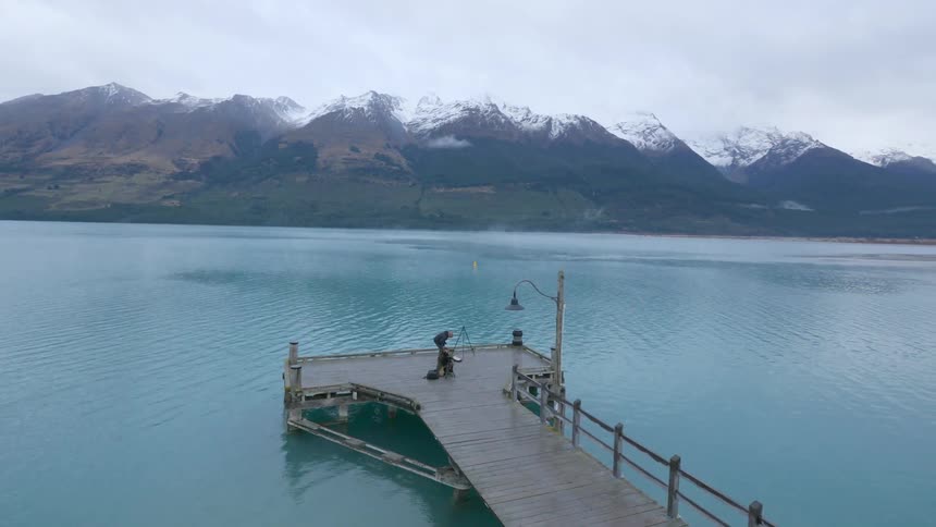 People are setting up tripods on the pier below