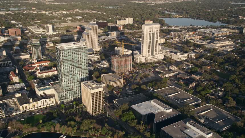 A stunning aerial view of office buildings in Downtown Orlando at sunrise showcasing the bustling metropolis of Floridas central district