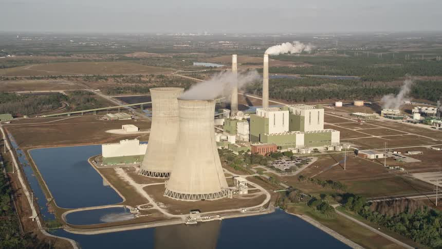 Aerial footage of Stanton Energy Center a power plant located in Orlando Florida shot at dawn showcasing the industrial might of the region
