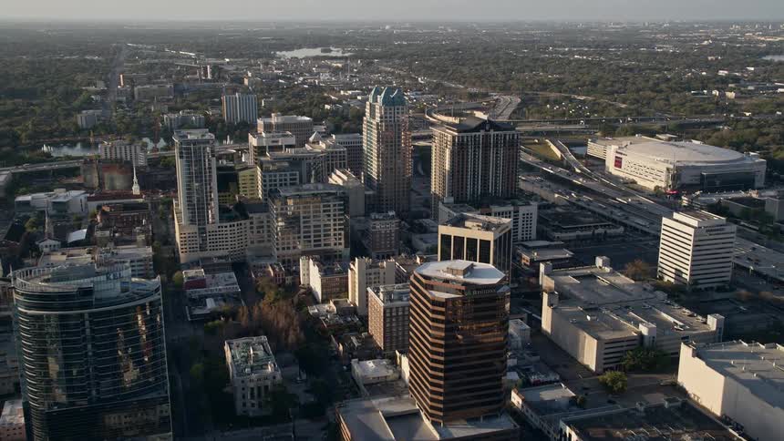 Flying over the courthouse and office buildings in the downtown area of Orlando Florida during a stunning sunrise