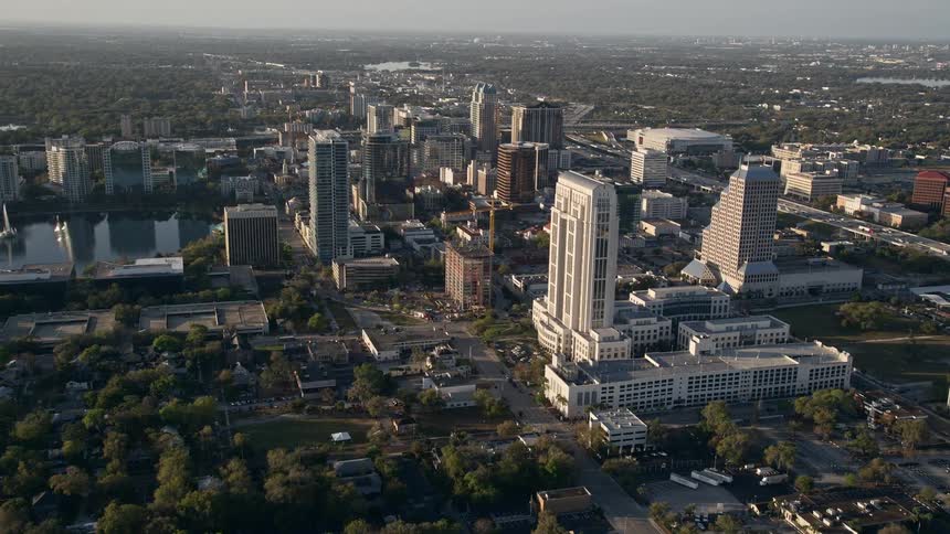 Aerial footage of Downtown Orlando Florida at sunrise flying over courthouse and office buildings