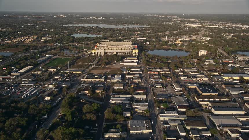 Aerial footage of the Citrus Bowl in Orlando Florida at sunrise tilting up from a nearby suburban neighborhood