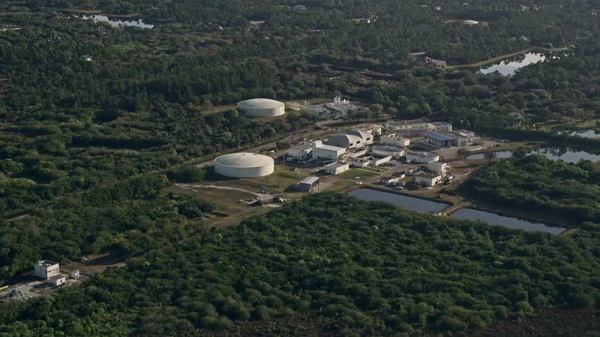 Aerial view of a water treatment plant in Melbourne Florida during sunrise situated among other industrial facilities